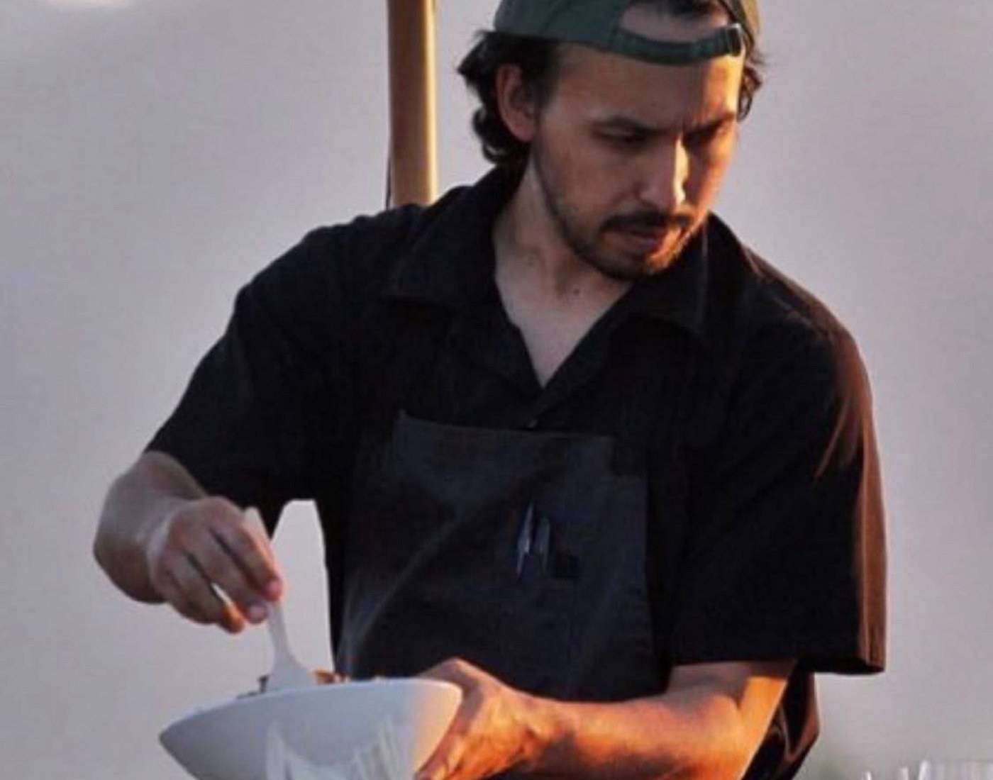 Chef Randy Leon cooking outdoors